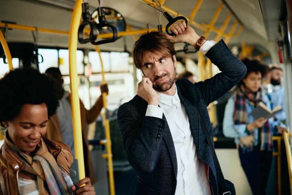 displeased-entrepreneur-making-phone-call-while-commuting-work-by-bus